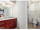 The bathroom includes a cherry vanity with great lighting, a mirror, and a toilet at 7111 N 63Rd Dr, Glendale, AZ 85301