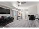 This bedroom boasts a television, ceiling fan, tiled floor, and large window at 7111 N 63Rd Dr, Glendale, AZ 85301