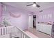 This delightful Bedroom boasts lavender walls, a crib, and a view of the closet at 7111 N 63Rd Dr, Glendale, AZ 85301
