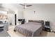 Spacious bedroom with a ceiling fan, tiled floor, and a workstation area at 7111 N 63Rd Dr, Glendale, AZ 85301