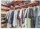 Walk-in closet featuring an abundance of storage space and organized clothing racks at 7111 N 63Rd Dr, Glendale, AZ 85301