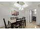 A bright dining room featuring a chandelier and a view of adjacent rooms through an open doorway at 7111 N 63Rd Dr, Glendale, AZ 85301