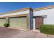 View of the garage door and gated entrance with well-maintained landscaping outside a residential property at 7111 N 63Rd Dr, Glendale, AZ 85301