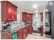 Updated kitchen with dark cabinetry, granite countertops, mosaic backsplash, and stainless steel appliances at 7111 N 63Rd Dr, Glendale, AZ 85301