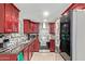 Modern kitchen featuring dark cabinetry, granite countertops, stainless steel appliances, and stylish backsplash at 7111 N 63Rd Dr, Glendale, AZ 85301