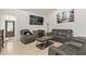 A cozy living room with modern leather seating, a fireplace, and tiled flooring at 7111 N 63Rd Dr, Glendale, AZ 85301