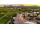 Aerial shot of desert homes with tile roofs and circular driveways overlooking a lush green golf course at 7475 E Gainey Ranch Rd # 22, Scottsdale, AZ 85258