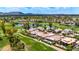 Expansive aerial view of luxury home on golf course with scenic lake and mountain views at 7475 E Gainey Ranch Rd # 22, Scottsdale, AZ 85258
