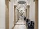 Long hallway with marble floors and arched entryways at 7475 E Gainey Ranch Rd # 22, Scottsdale, AZ 85258