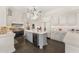 Spacious kitchen showcasing a center island, white cabinetry, and stainless steel appliances at 7475 E Gainey Ranch Rd # 22, Scottsdale, AZ 85258