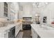 Luxury kitchen showcasing white cabinets, marble countertops, and a black Viking stove at 7475 E Gainey Ranch Rd # 22, Scottsdale, AZ 85258