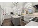 Bright kitchen with a large island, white cabinets, and views to the living room at 7475 E Gainey Ranch Rd # 22, Scottsdale, AZ 85258