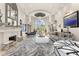 Bright living room features fireplace, grand window, and elegant finishes creating a comfortable atmosphere at 7475 E Gainey Ranch Rd # 22, Scottsdale, AZ 85258