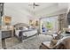 Cozy main bedroom featuring a sitting area, plush carpet, and French doors to outdoor patio at 7475 E Gainey Ranch Rd # 22, Scottsdale, AZ 85258