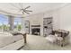 Sun-drenched main bedroom with sitting area, fireplace, and access to the outdoor pool area at 7475 E Gainey Ranch Rd # 22, Scottsdale, AZ 85258