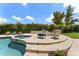 Inviting pool and spa area surrounded by elegant stone patio, comfortable seating, and manicured greenery at 7475 E Gainey Ranch Rd # 22, Scottsdale, AZ 85258