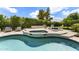 Beautiful outdoor pool area with a relaxing spa, stylish lounge chairs, and lush landscaping at 7475 E Gainey Ranch Rd # 22, Scottsdale, AZ 85258