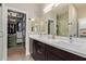 Modern bathroom with double vanity, glass-enclosed shower, and walk-in closet at 820 N 8Th Ave # 14, Phoenix, AZ 85007