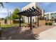 Exterior shot of shared outdoor patio area with pergola, stone picnic table, grill and brick pavers at 820 N 8Th Ave # 14, Phoenix, AZ 85007