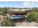 Aerial view of home with a private pool, retaining wall, and desert landscaping at 9030 E Trail Dr, Carefree, AZ 85377