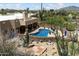 Aerial view showing the rear of the house, pool, retaining wall, and desert landscaping at 9030 E Trail Dr, Carefree, AZ 85377