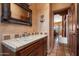 Bathroom featuring decorative mirror, single sink, and access to the adjacent living area at 9030 E Trail Dr, Carefree, AZ 85377