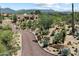 Stunning home exterior with desert landscaping, winding driveway, and mountain views at 9030 E Trail Dr, Carefree, AZ 85377