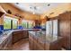 Bright kitchen featuring an island, Saltillo tile flooring, and stainless steel appliances at 9030 E Trail Dr, Carefree, AZ 85377