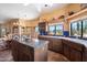 Kitchen with dark wood cabinets, an island with granite countertops, and tile flooring at 9030 E Trail Dr, Carefree, AZ 85377