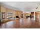 Expansive living room with tile flooring, corner fireplace, large windows, and open floor plan at 9030 E Trail Dr, Carefree, AZ 85377