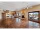 Bright living room with tile floors, fireplace and views of the outdoor pool area at 9030 E Trail Dr, Carefree, AZ 85377