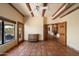 Bright living room with terracotta tile floors, beamed ceilings, and abundant natural light at 9030 E Trail Dr, Carefree, AZ 85377