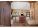 Spacious living room with Saltillo tile, wood columns, fireplace, and natural light at 9030 E Trail Dr, Carefree, AZ 85377