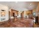 An elegant living room with rustic columns, a fireplace, Saltillo tile and open spaces at 9030 E Trail Dr, Carefree, AZ 85377