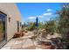 Outdoor patio area with stone pavers and a table, chairs, and umbrella at 9030 E Trail Dr, Carefree, AZ 85377