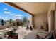 Charming covered patio with stone flooring and decorative pottery, overlooking the private courtyard at 9030 E Trail Dr, Carefree, AZ 85377