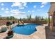 Desert-themed pool area with rock features, desert plants, and partial shade from covered patio at 9030 E Trail Dr, Carefree, AZ 85377
