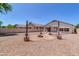 Spacious backyard with desert landscaping featuring unique barrel planters and a central fire pit at 925 W San Marcos Dr, Chandler, AZ 85225