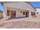 Covered patio featuring sliding glass doors opens to a low-maintenance backyard with gravel and defined walkways at 925 W San Marcos Dr, Chandler, AZ 85225