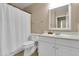 Clean bathroom featuring a shower with a white curtain, a toilet, and a vanity with storage at 925 W San Marcos Dr, Chandler, AZ 85225