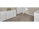 Comfortable bedroom with neutral carpet, a dresser, and a glimpse into an adjacent space at 925 W San Marcos Dr, Chandler, AZ 85225