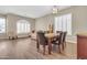 Open-concept dining room flowing into the living room with modern wood floors and elegant decor at 925 W San Marcos Dr, Chandler, AZ 85225