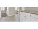 Hallway view to the kitchen features white cabinetry and countertops at 925 W San Marcos Dr, Chandler, AZ 85225