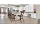 Bright kitchen featuring white cabinets, stainless steel appliances, a center island with seating, and tile flooring at 925 W San Marcos Dr, Chandler, AZ 85225