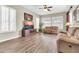 Cozy living room with wood-look floors, ceiling fan, and bright windows with white shutters at 925 W San Marcos Dr, Chandler, AZ 85225