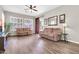 Bright living room with wood-look floors, large windows with shutters and access to the patio at 925 W San Marcos Dr, Chandler, AZ 85225