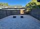Well-maintained private backyard with a paved patio area, gravel landscaping, and wooden fence at 10101 N 91St Ave # 88, Peoria, AZ 85345