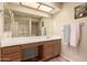 Spacious bathroom with a long vanity, a large mirror, and accessible shower with grab bars at 1021 S Greenfield Rd # 1165, Mesa, AZ 85206