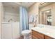 A bathroom with a walk-in bathtub, shower, and a single vanity at 1021 S Greenfield Rd # 1165, Mesa, AZ 85206