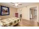 Comfortable bedroom featuring a ceiling fan, hardwood floors, and ensuite bathroom with grab bars at 1021 S Greenfield Rd # 1165, Mesa, AZ 85206